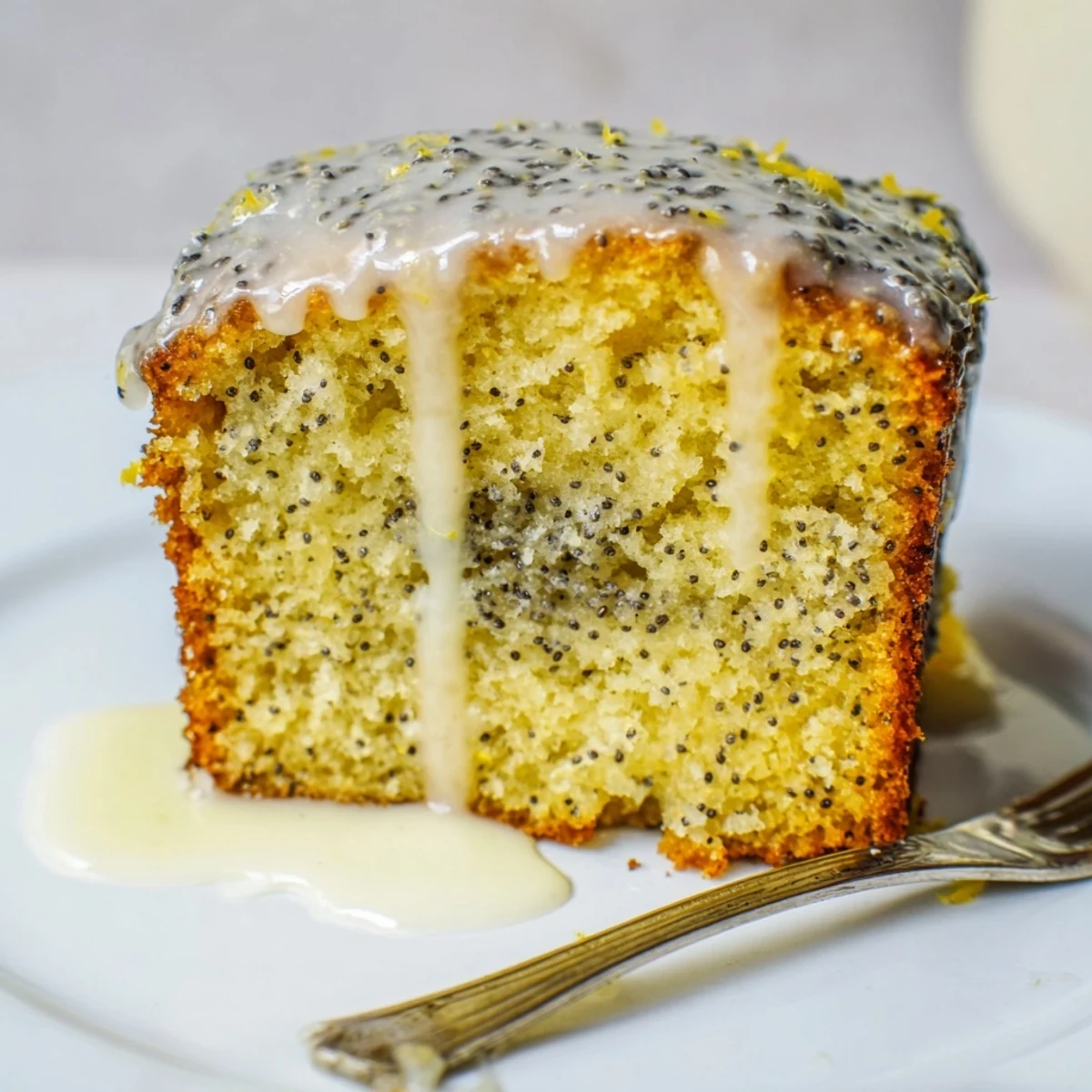 Moist mini lemon poppy seed loaves drizzled with zesty lemon glaze, delightful treat.  