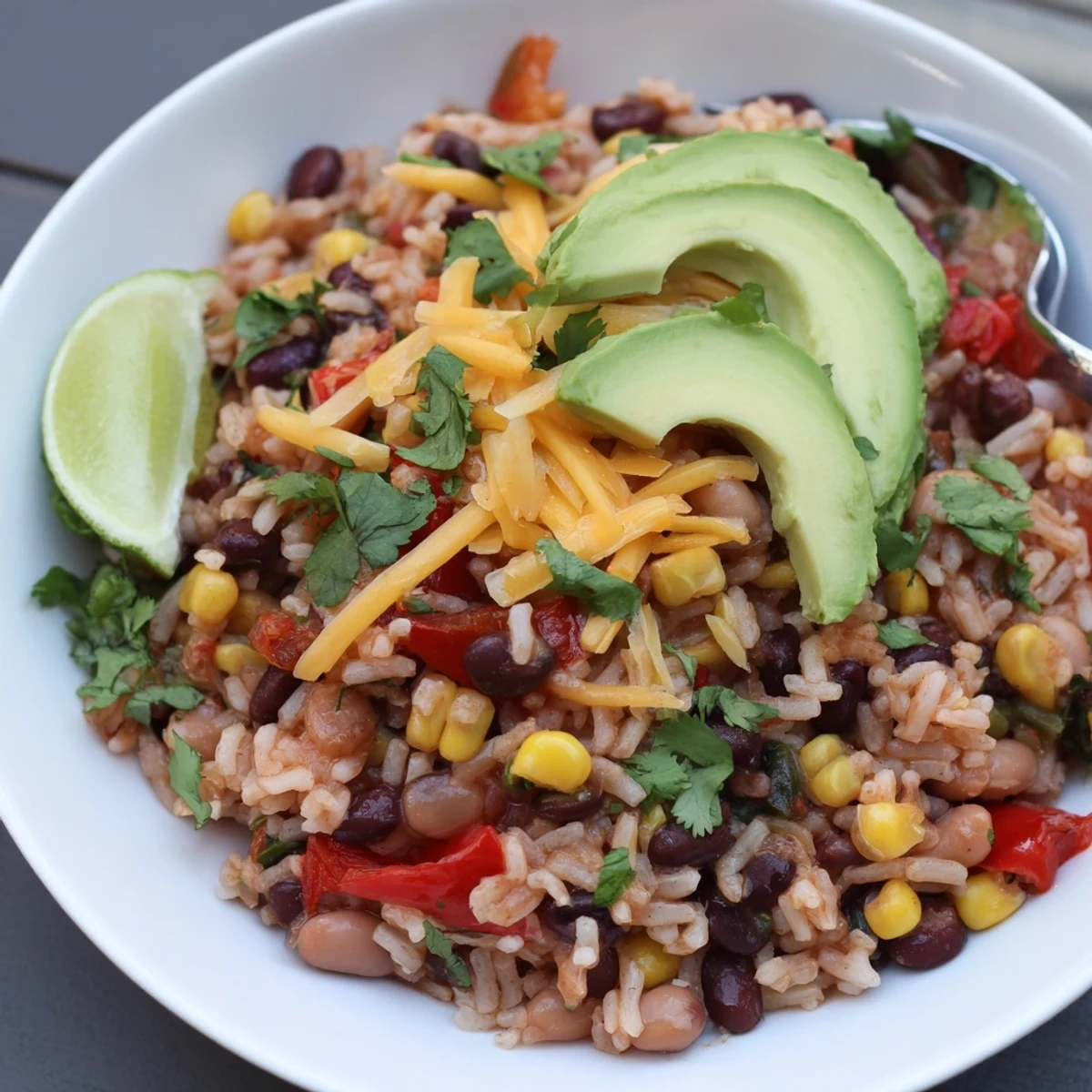 Savory One-Pan Mexican Rice and Beans, garnished with fresh cilantro and lime wedges.  