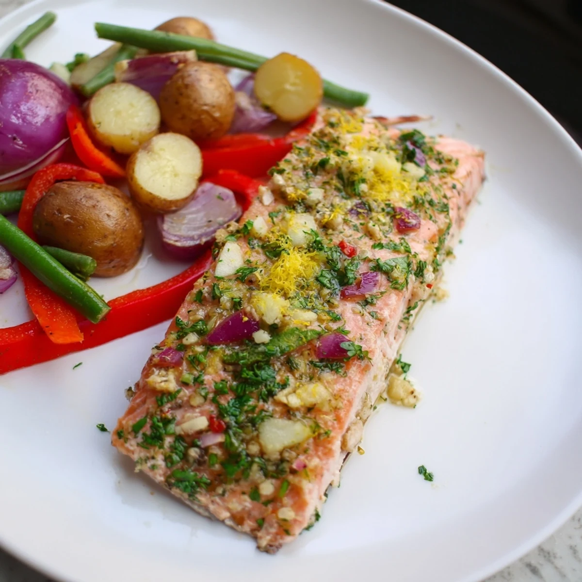 Golden roasted potatoes and tender, flaky Lemon Herb Salmon, a complete sheet pan dinner.