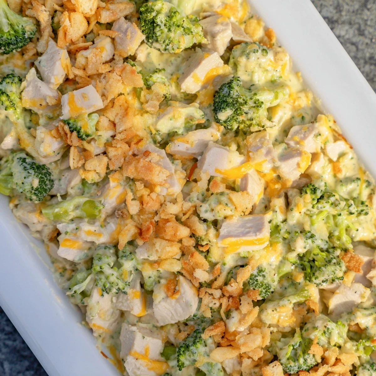 Close-up of a bubbling Chicken & Broccoli Cheddar Bake, revealing a cheesy, flavorful, and complete meal.