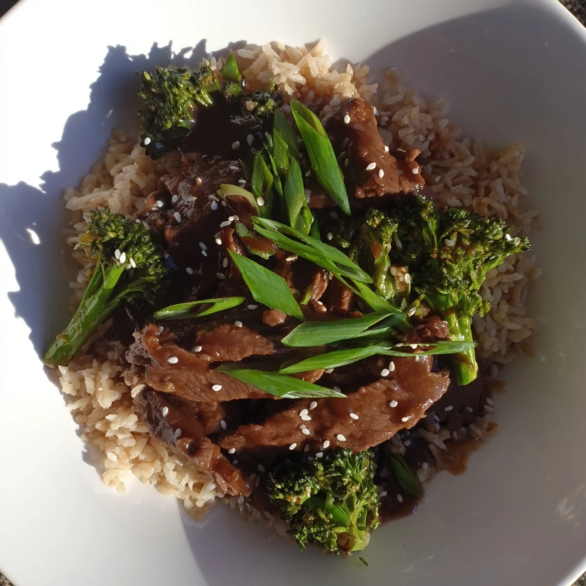 Tender Slow-Cooker Beef & Broccoli rests on fluffy brown rice, looking and smelling delicious.