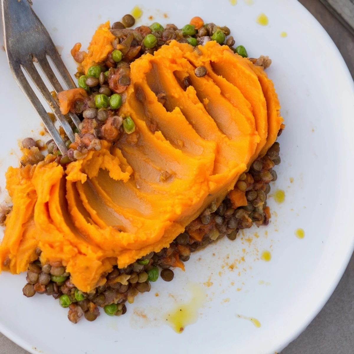 A baked veggie shepherds pie shows a creamy sweet potato topping over rich lentil filling.
