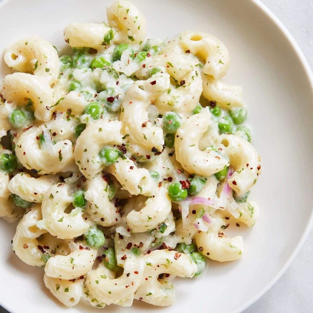Steaming bowl of creamy Macaroni & Peas, a quick and comforting vegetarian weeknight dinner.