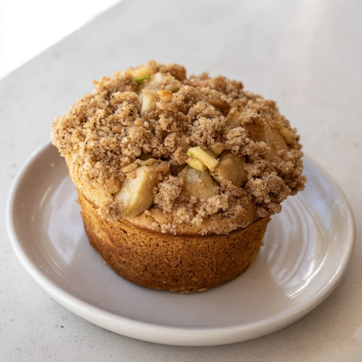 Freshly baked tasty apple muffins, perfect for sharing, with visible apple chunks and spiced aroma.