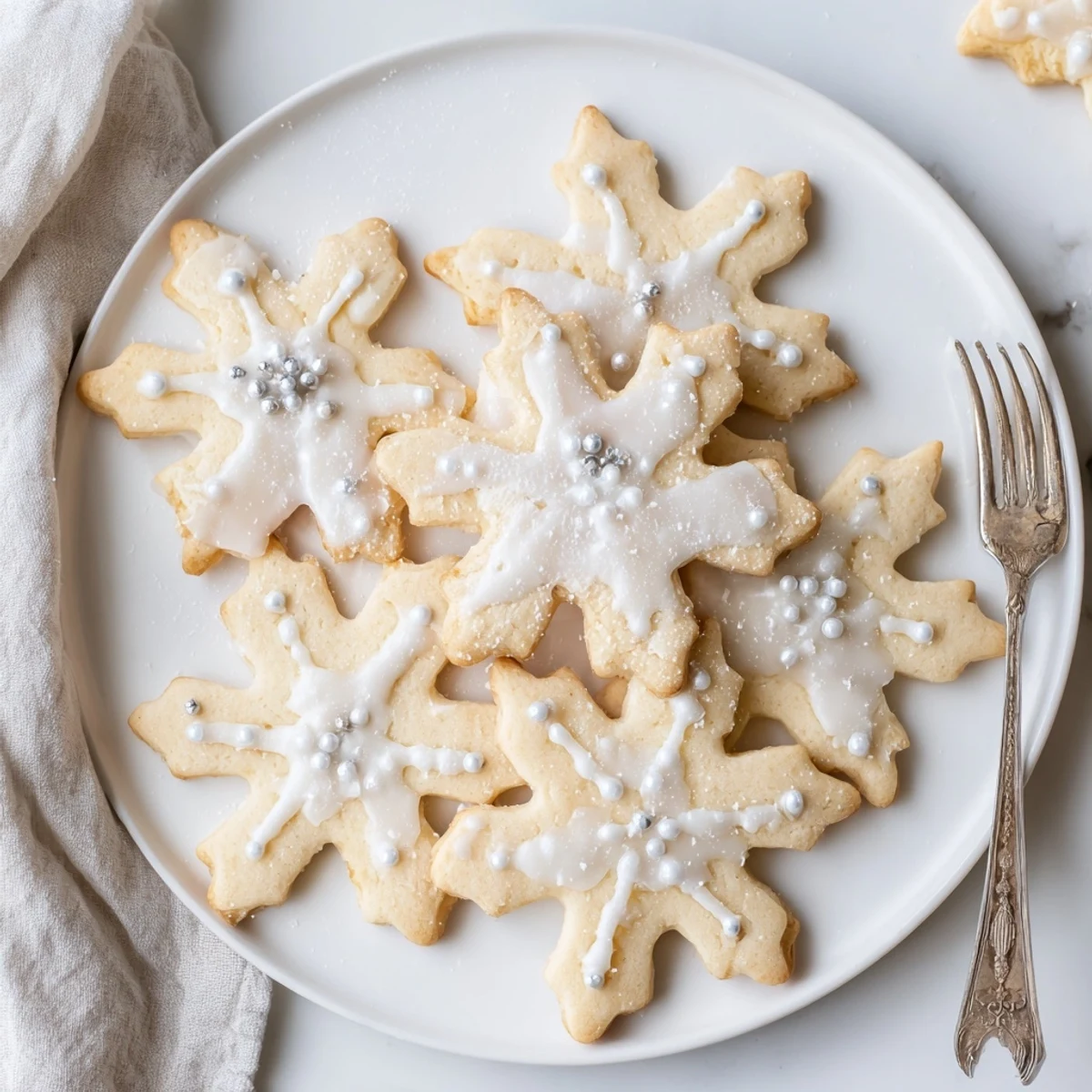 A glistening Winter Snowflake Platter, featuring crisp, white cookies elegantly decorated for the holidays.