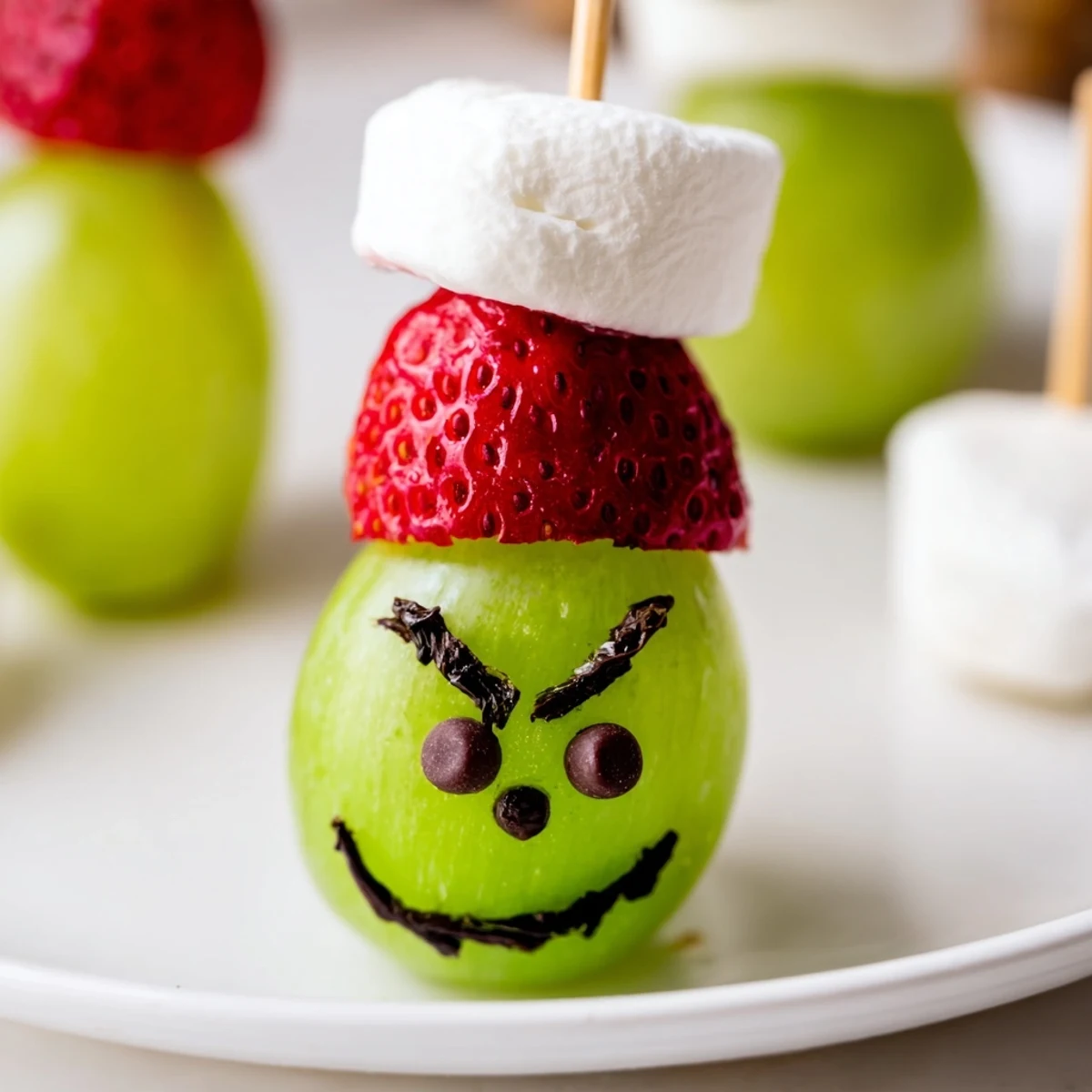 Quick and easy Grinch Snack: Marshmallows, green grapes, and strawberries make cute treats.