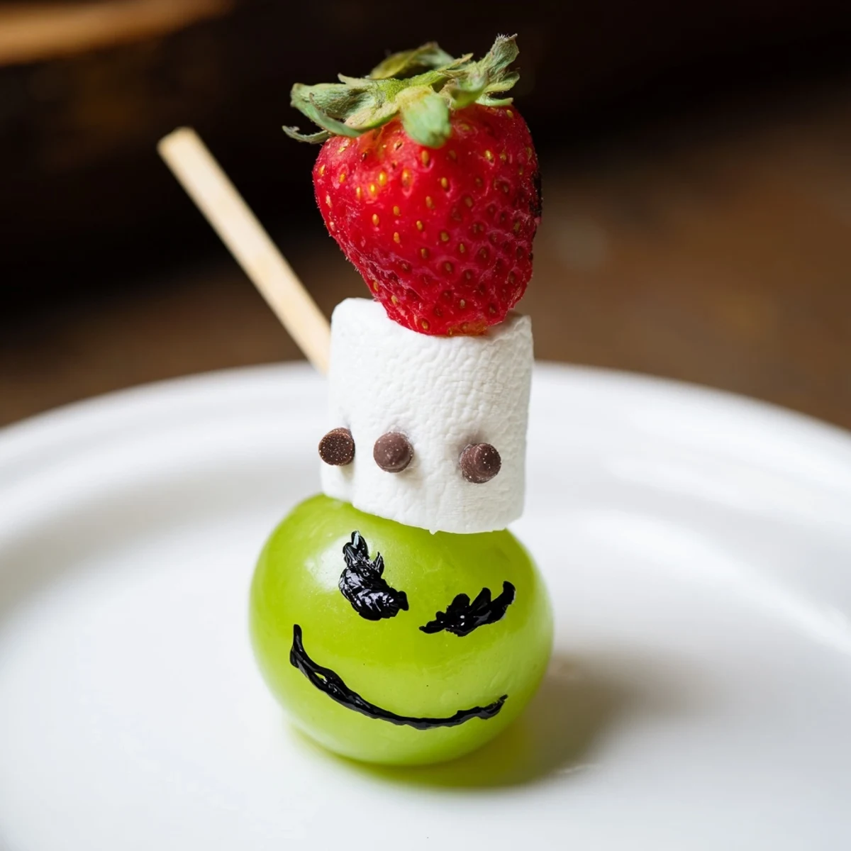 Kid-friendly Grinch snack features cheerful Grinch faces using fresh green grapes and fruit.
