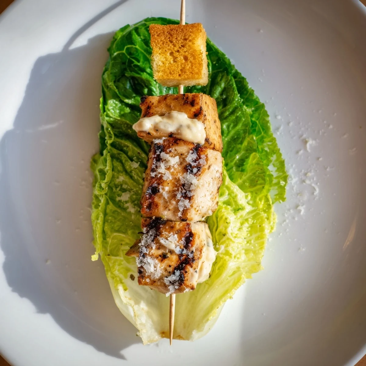 Grilled Chicken Caesar salad skewers arranged beautifully on a serving plate, ready to enjoy.