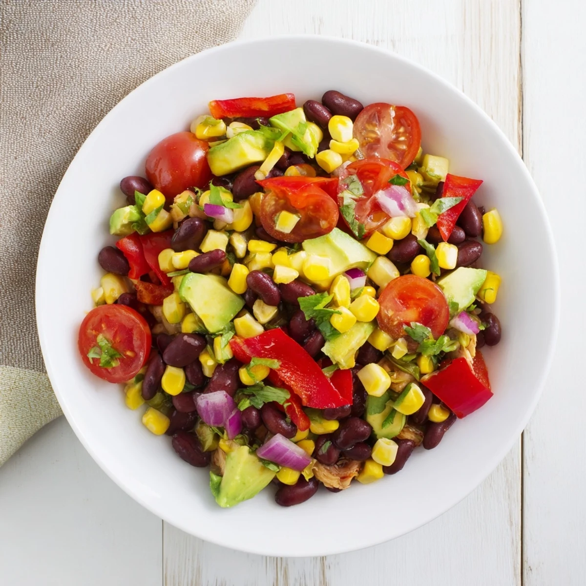 A vibrant bowl of Dense Southwestern Bean Salad, perfect for summer gatherings, awaits.