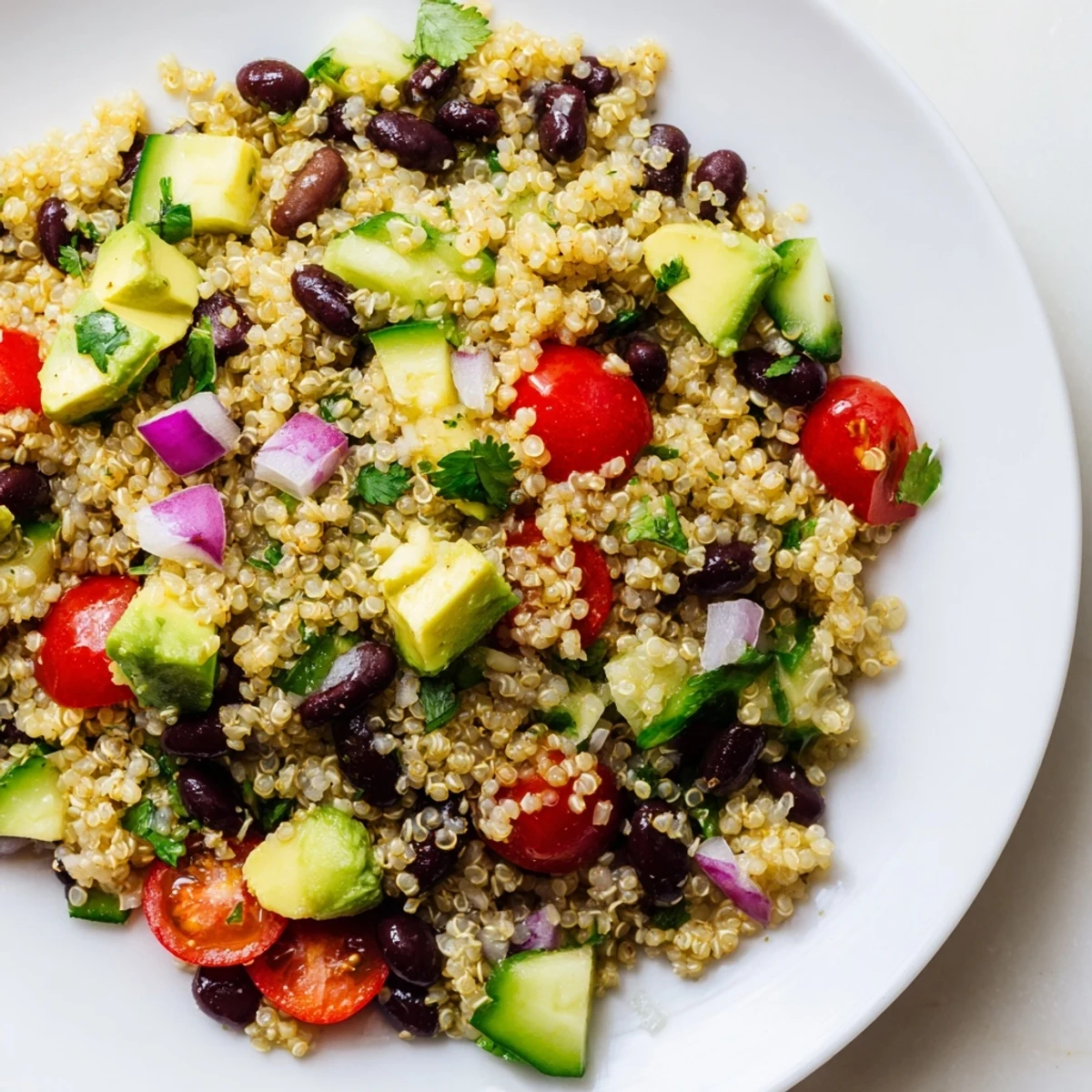 Chilled quinoa black bean salad, a vegetarian delight combining fresh veggies and zesty flavors.