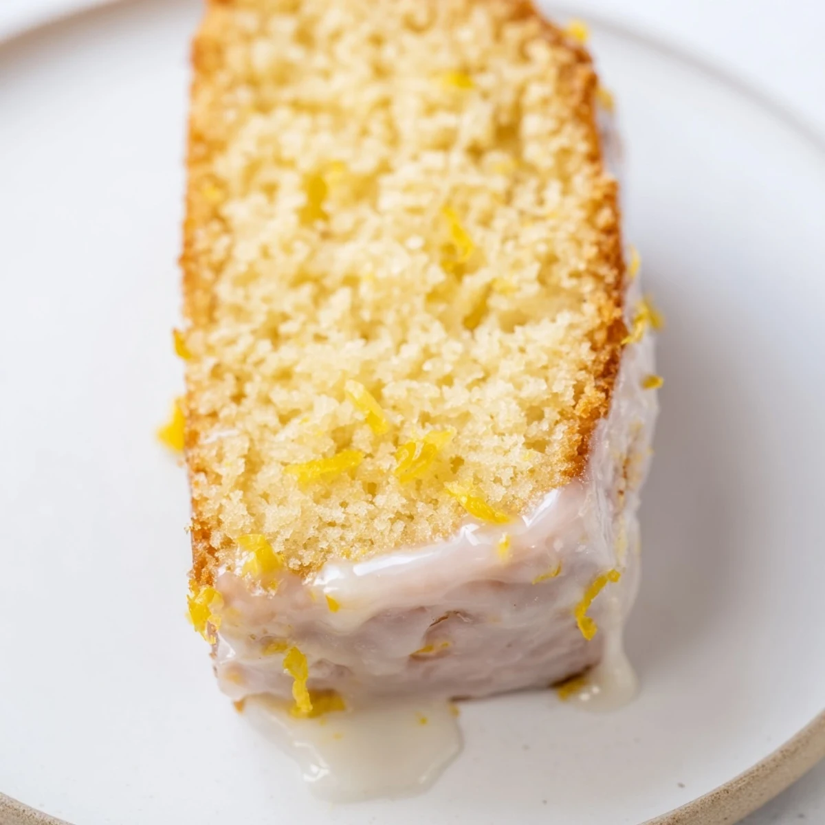 A homemade lemon yogurt cake, presented with delicious glaze, tempting for a sweet, refreshing treat.