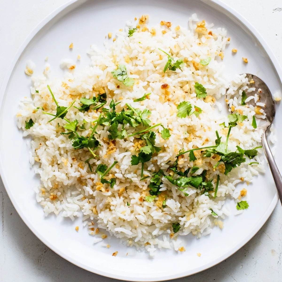 Steam rises from tender Jasmine Rice Garlic, perfectly cooked beside Asian-inspired stir-fry in a rustic bowl.