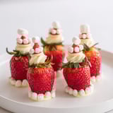Fresh strawberries, cleverly transformed into playful Air Fryer Santa Hat Strawberries, perfect for a Christmas party dessert.