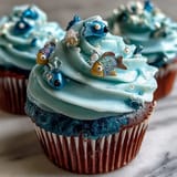 Whimsical Pisces cupcakes topped with handcrafted fondant fish in vibrant colors, perfect for zodiac-themed parties.