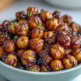 Golden-brown baked chickpeas tossed with zesty chili lime seasoning for a spicy, tangy treat.