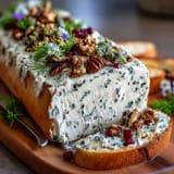 Creamy butter spread topped with honey, capers, and microgreens, ready for dipping with assorted crackers and bread.