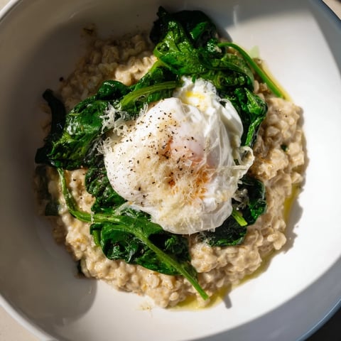 Savory Oatmeal topped with spinach and a perfectly poached egg, a vibrant breakfast.