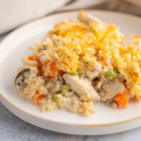 Steaming Chicken and Wild Rice Bake, golden-brown crust, creamy sauce bubbling, ready to serve a family.