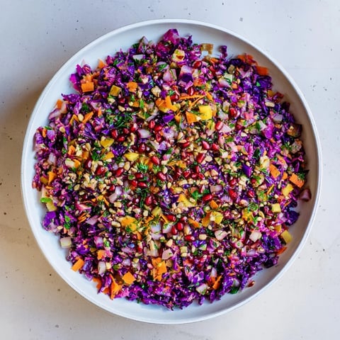 Vibrant Shirazi-Inspired Winter Slaw, a colorful mix of shredded cabbage and herbs, ready to serve.