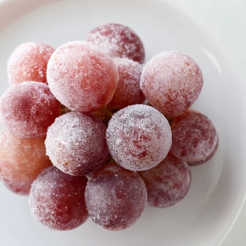 Icy, freshly frozen grapes ready to enjoy, a simple, delicious snack perfect for summer.