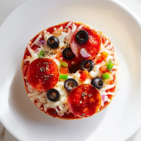 Golden cheese bubbling atop mini bagel pizzas, perfect for a quick and cheesy snack.