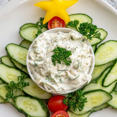 Vibrant Cucumber and tomato tree dip showcasing a creamy dip surrounded by fresh veggies, a party favorite.