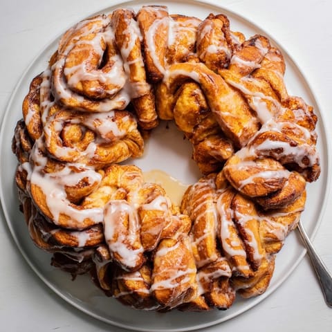 Warm, gooey cinnamon roll pull-apart wreath with a rich cinnamon sugar filling, ready to enjoy.
