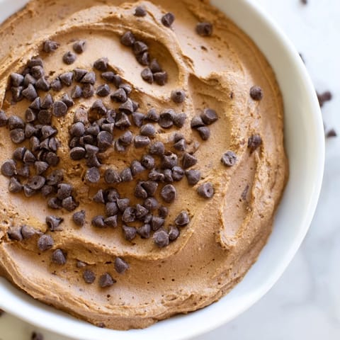 This creamy Brownie Batter Dip, swirled with chocolate chips, is ideally served with fresh fruit.