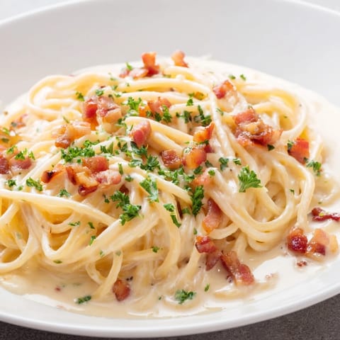 Golden, crispy bacon bits topping the creamy garlic bacon pasta, ready for an Italian-inspired meal.