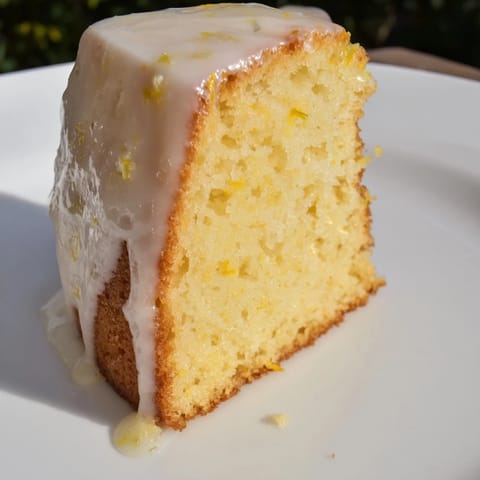 Golden-brown lemon yogurt cake, showcasing its moist texture and bright lemon zest flavor.