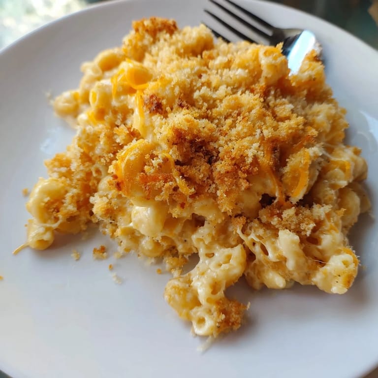 A close-up shot of rich and creamy Old-Fashioned Baked Mac & Cheese, fresh from the oven, ready to serve.
