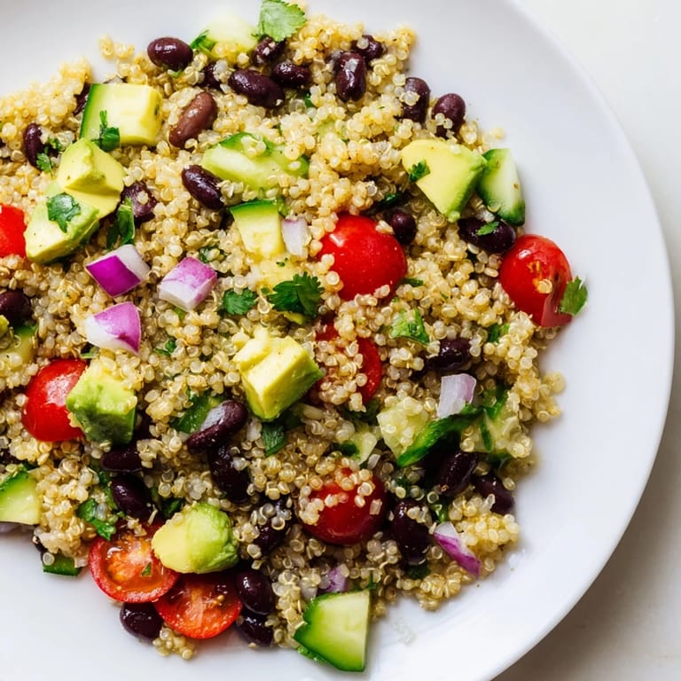 Chilled quinoa black bean salad, a vegetarian delight combining fresh veggies and zesty flavors.