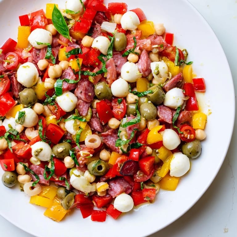 Hearty Crunchy Antipasto Chopped Salad served with fresh basil and crisp vegetables on a rustic table.