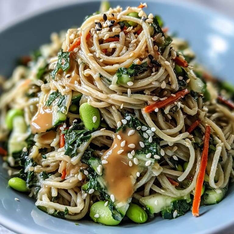 Refreshing Sesame Ginger Noodle Bowl featuring chilled noodles, crunchy veggies, and a savory-sweet sesame dressing.