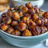 Crispy baked chickpeas seasoned with smoky paprika, cumin, and garlic for a crunchy, protein-rich snack.